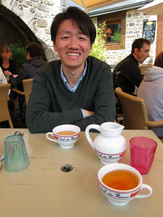 Zhizhong at lunch in Dinan, with Breton cider.