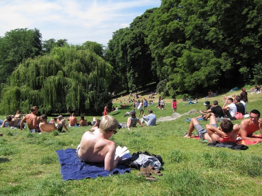 Sunbathers on the field below Rosa Bonheur in the Parc des Buttes-Chaumont on a sunny Sunday.